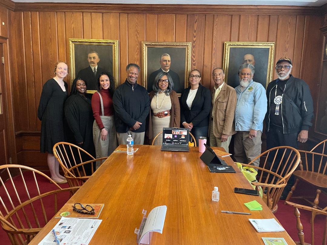 Group standing around a table at the VCU Massey Cancer meeting in the Walter Cecil Rawls Library