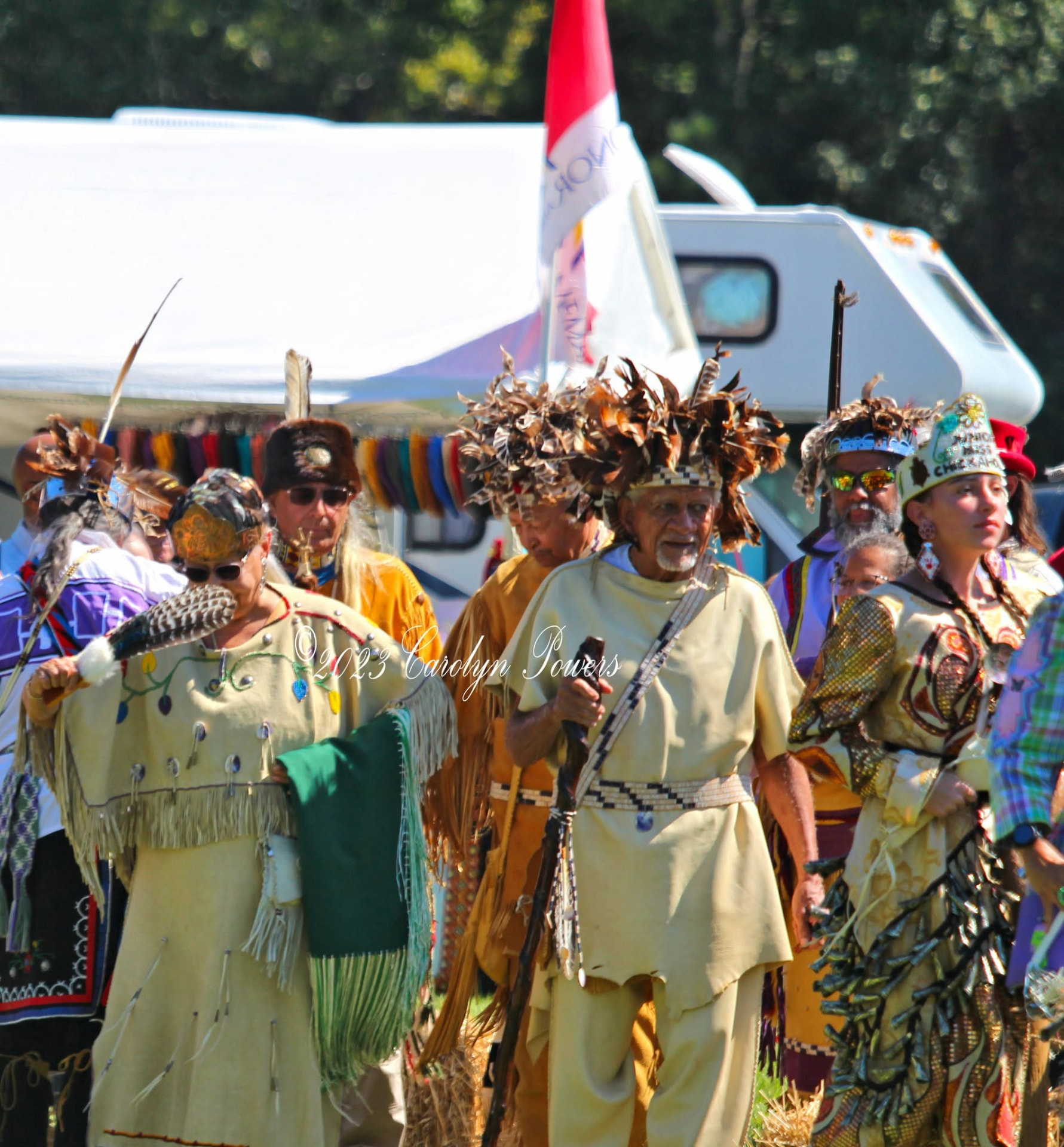 Tribal elders in feathered headdresses during Grand Entry