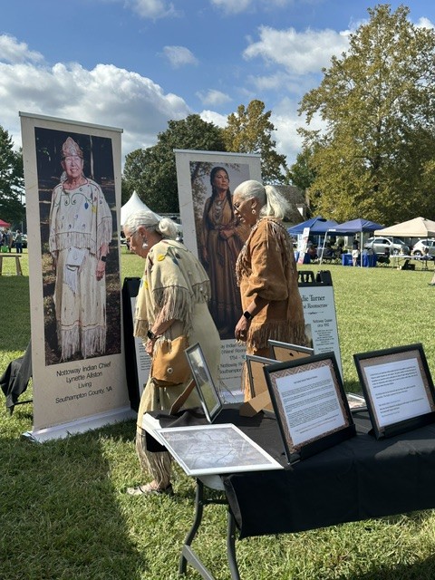 A display banner telling the story of Chief Lynette Allston at the powwow