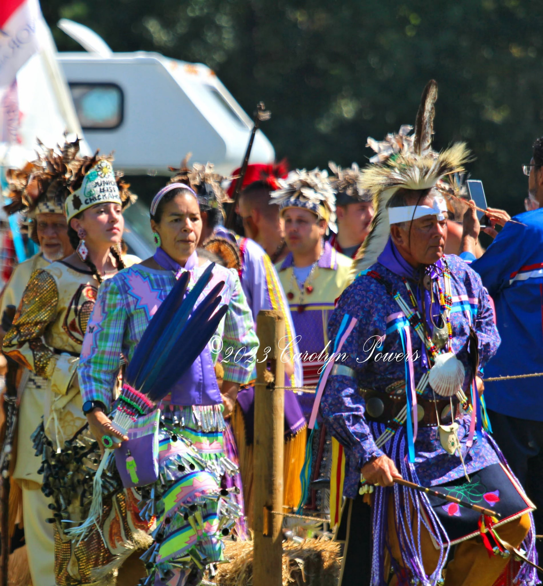 Dancers in bright regalia entering the powwow arena
