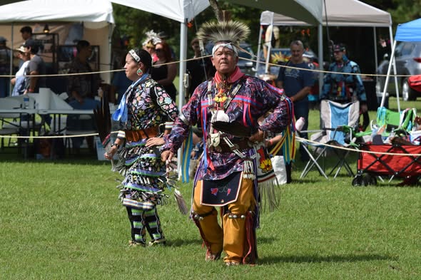 Fancy dancers in vibrant regalia during a powwow