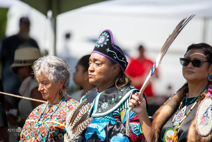 Nottoway dancer holding a feather fan during ceremony